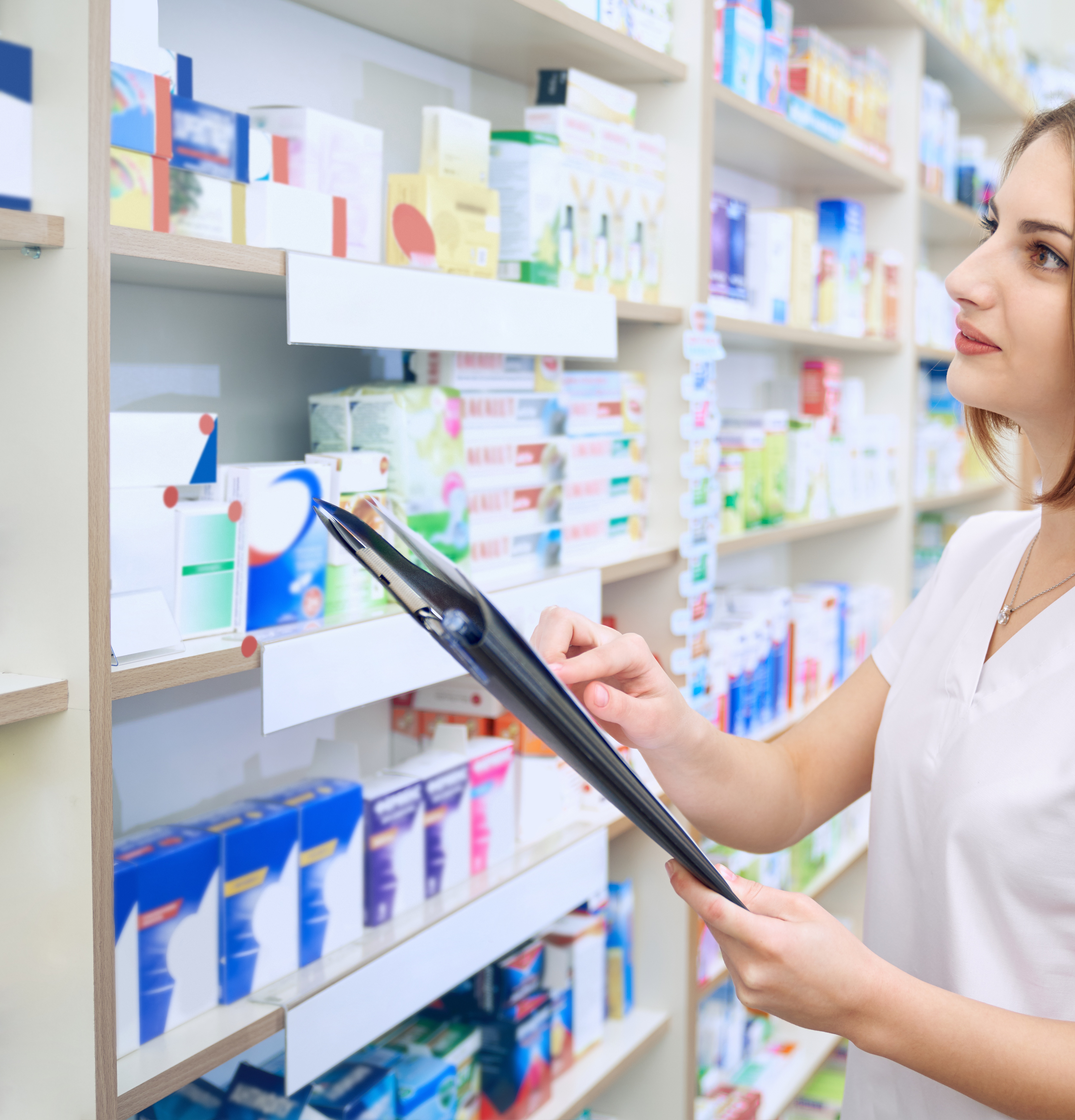 female-pharmacist-with-folder-examinating-medicaments